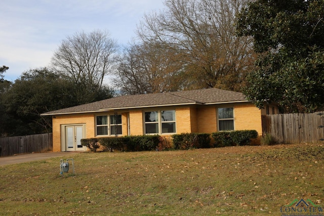 single story home featuring french doors and a front yard