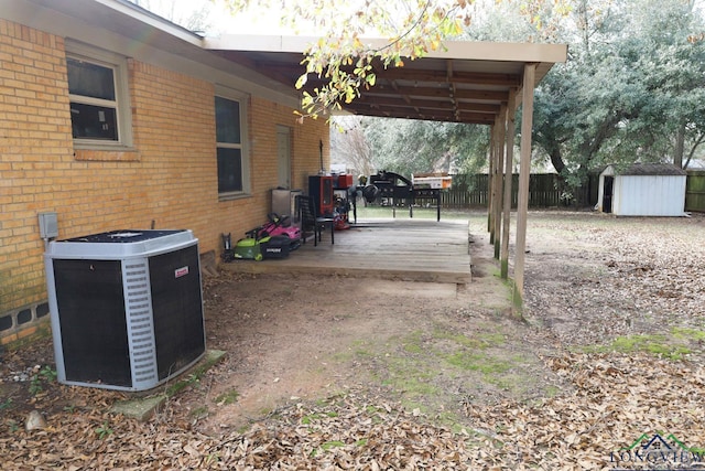 view of yard with central AC unit and a storage unit