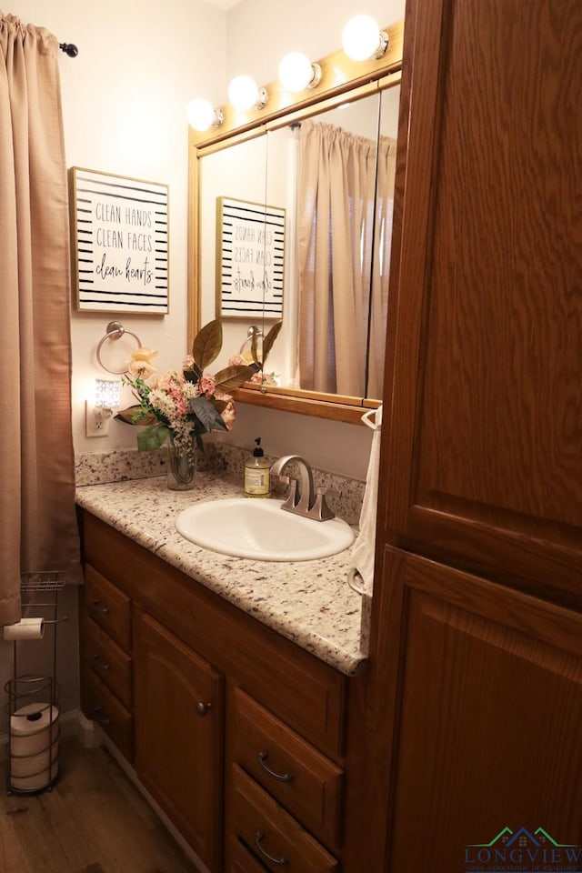 bathroom with hardwood / wood-style floors and vanity