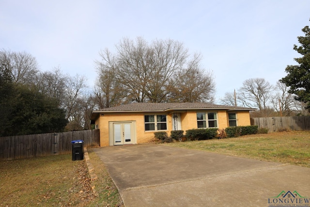 single story home featuring french doors and a front yard