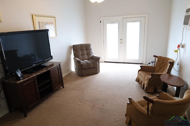 carpeted living room with french doors and an AC wall unit