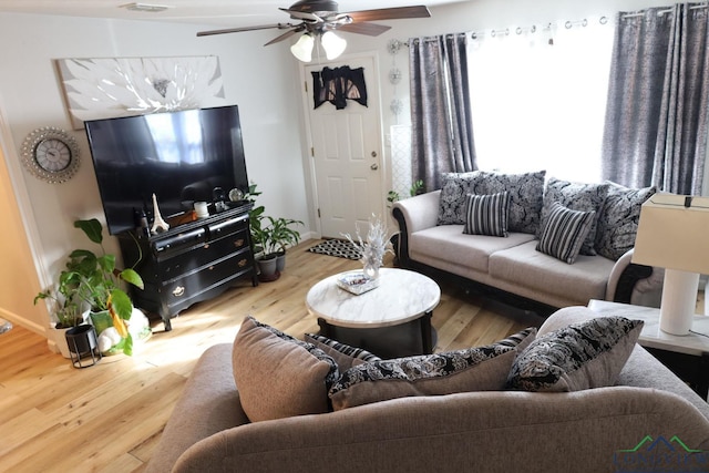 living room with hardwood / wood-style flooring and ceiling fan