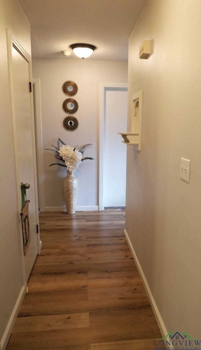 corridor featuring dark hardwood / wood-style floors