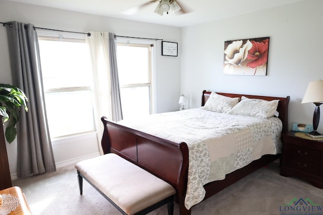 bedroom featuring carpet, ceiling fan, and multiple windows