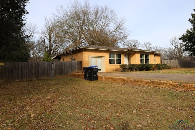 view of side of home with a yard