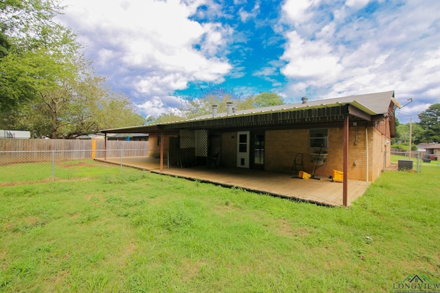 back of house with a lawn