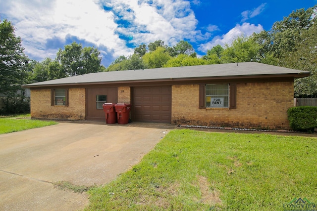 single story home with a garage and a front lawn