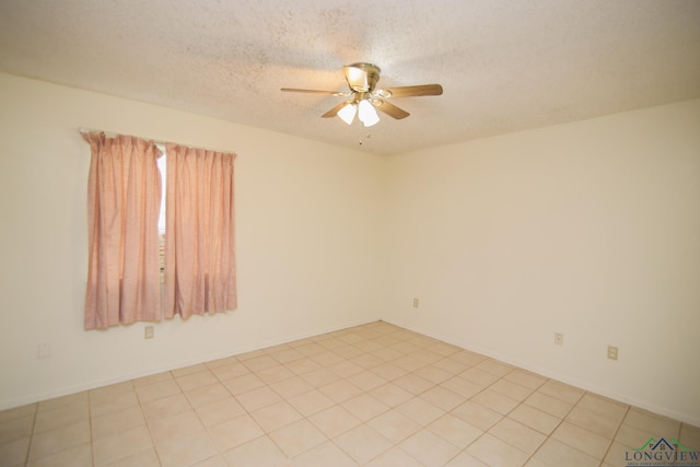 unfurnished room featuring light tile patterned floors, a textured ceiling, and ceiling fan