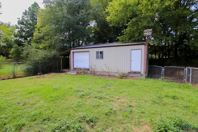 view of outdoor structure with a yard and a carport