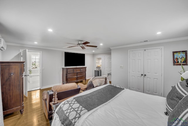 bedroom featuring crown molding, ceiling fan, a wall mounted AC, a closet, and light wood-type flooring