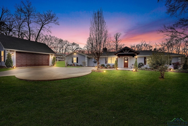 single story home with a garage and a yard