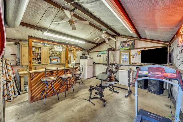 exercise area with lofted ceiling, ceiling fan, and indoor bar