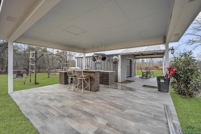 view of patio featuring exterior bar and a deck