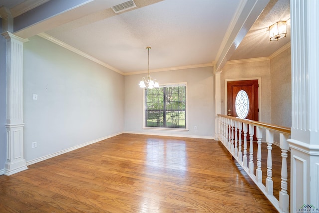 9211 Elm Tree Cir, Tyler, TX 75703 - unfurnished room featuring wood finished floors, decorative columns, crown molding, a chandelier, and baseboards
