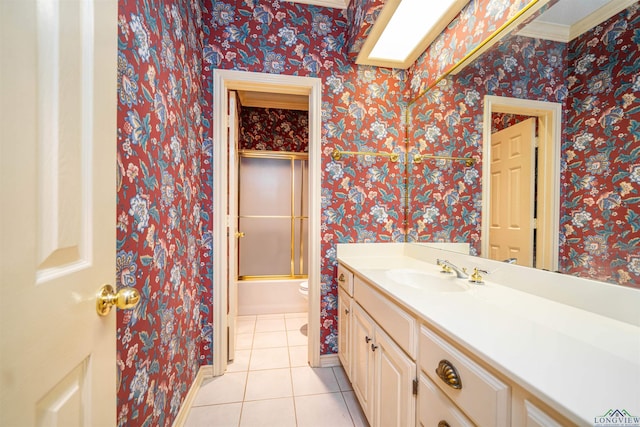9211 Elm Tree Cir, Tyler, TX 75703 - full bath with tile patterned floors, vanity, baseboards, toilet, and shower / bath combination with glass door