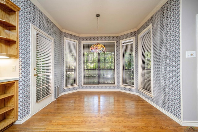 9211 Elm Tree Cir, Tyler, TX 75703 - unfurnished dining area featuring crown molding, wallpapered walls, wood finished floors, and baseboards