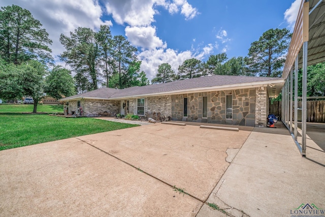 3365 Omie Dr, Longview, TX 75605 - rear view of house with stone siding and a patio area