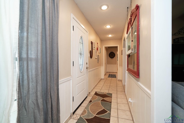 3365 Omie Dr, Longview, TX 75605 - hallway featuring light tile patterned floors, wainscoting, and recessed lighting