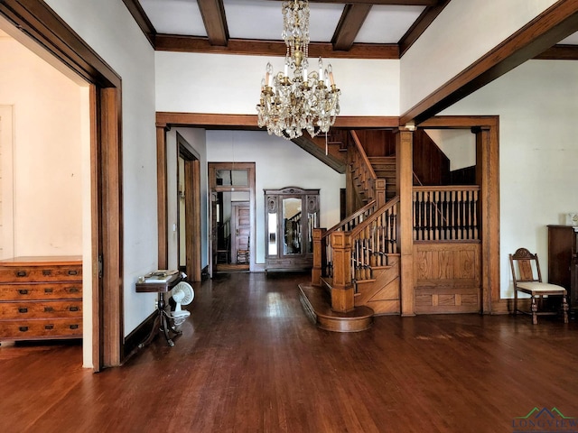 foyer entrance with beamed ceiling, dark hardwood / wood-style floors, and a chandelier