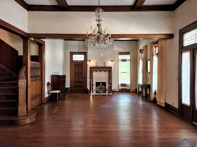 unfurnished living room with dark hardwood / wood-style flooring, beamed ceiling, and an inviting chandelier