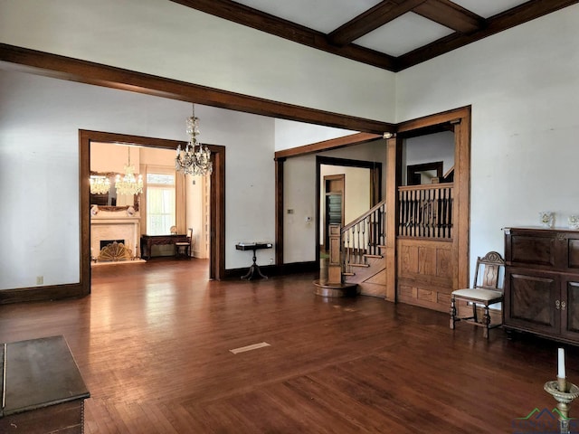 interior space featuring coffered ceiling, dark hardwood / wood-style floors, beamed ceiling, and a chandelier