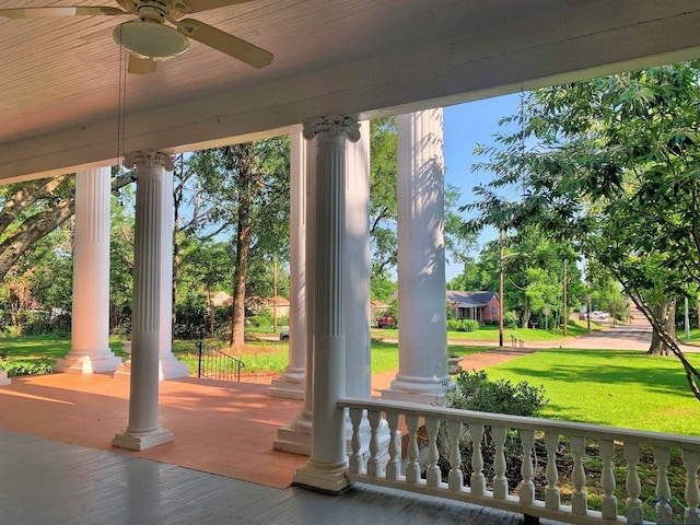 exterior space featuring covered porch, a yard, and ceiling fan