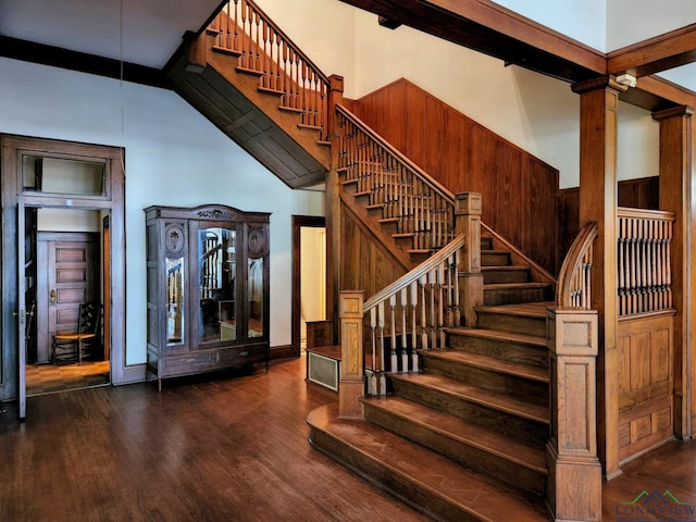 stairs with wood-type flooring and ornate columns