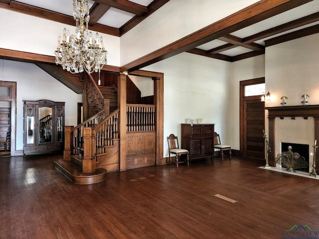 entrance foyer with beam ceiling, coffered ceiling, dark hardwood / wood-style floors, and a notable chandelier