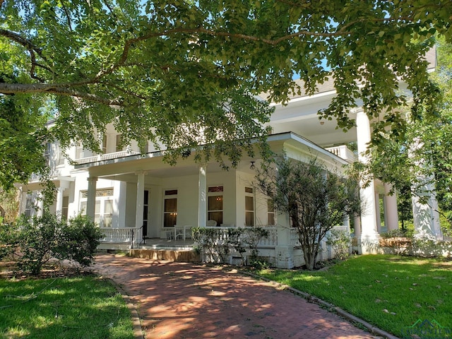 view of front of house featuring a porch and a balcony