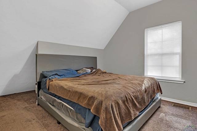 carpeted bedroom featuring lofted ceiling