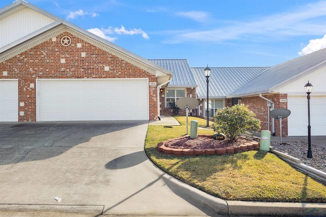 view of front of home featuring a garage and a front lawn