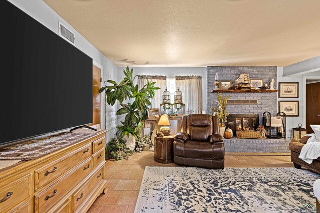 living room featuring a fireplace and a textured ceiling