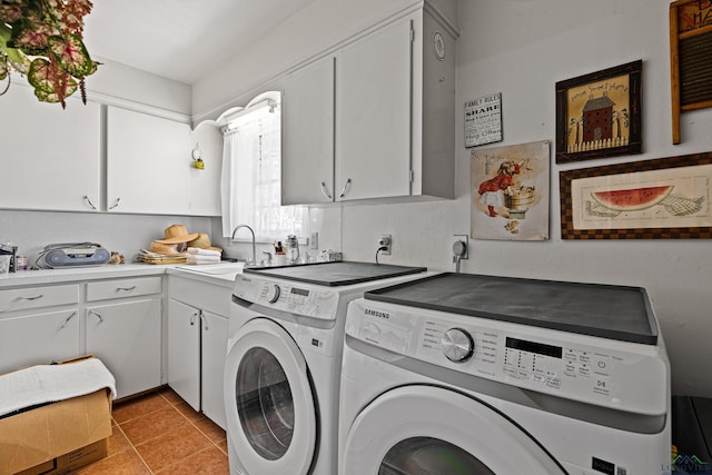 clothes washing area featuring cabinets, washing machine and clothes dryer, sink, and light tile patterned floors