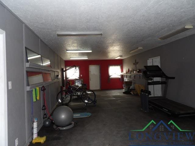 gym featuring a textured ceiling