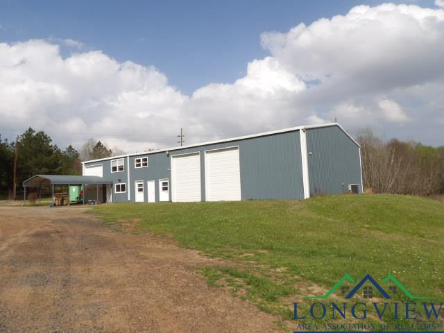 view of outbuilding with a lawn and a carport