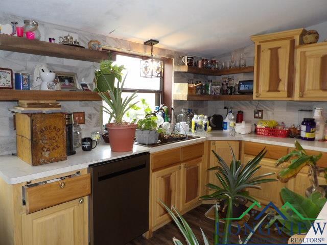 kitchen featuring a chandelier, black dishwasher, and tasteful backsplash