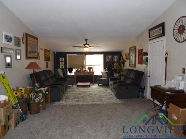 living room with carpet, ceiling fan, and lofted ceiling