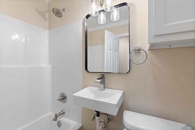 bathroom with shower / bathtub combination, a sink, toilet, and crown molding