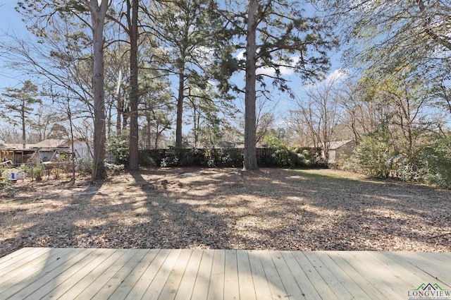 view of yard featuring fence and a wooden deck