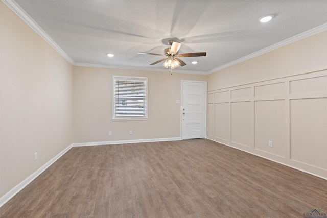 unfurnished room featuring ceiling fan, crown molding, baseboards, and wood finished floors