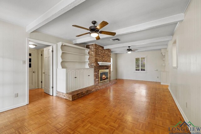 3 Ramblewood Dr, Longview, TX 75605 - unfurnished living room featuring a ceiling fan, beamed ceiling, baseboards, and a brick fireplace