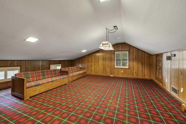 3 Ramblewood Dr, Longview, TX 75605 - additional living space featuring wood walls, a textured ceiling, vaulted ceiling, carpet, and baseboards