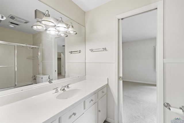 3 Ramblewood Dr, Longview, TX 75605 - bathroom with vanity, enclosed tub / shower combo, toilet, and wainscoting