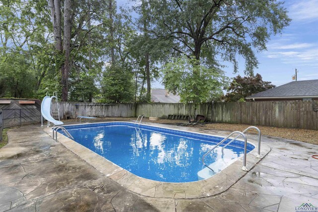 3 Ramblewood Dr, Longview, TX 75605 - view of swimming pool with a patio area, a fenced backyard, and a water slide