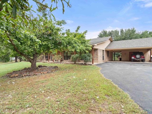 view of front of house with a front yard and a carport