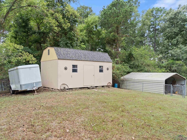 view of outbuilding featuring a carport and a lawn