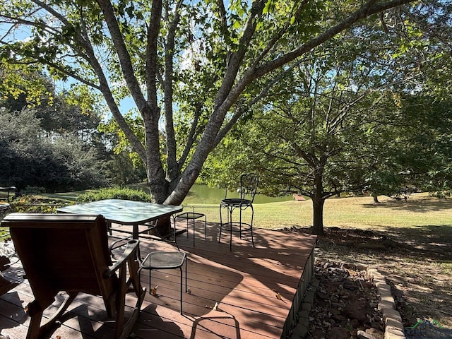 wooden terrace featuring a yard