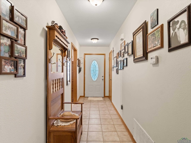 doorway with light tile patterned floors