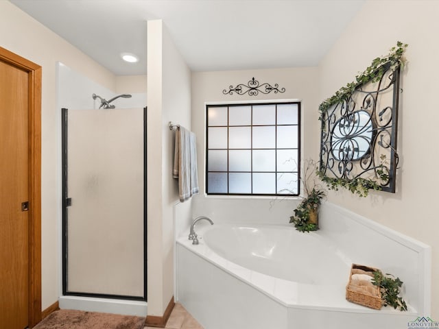 bathroom featuring independent shower and bath