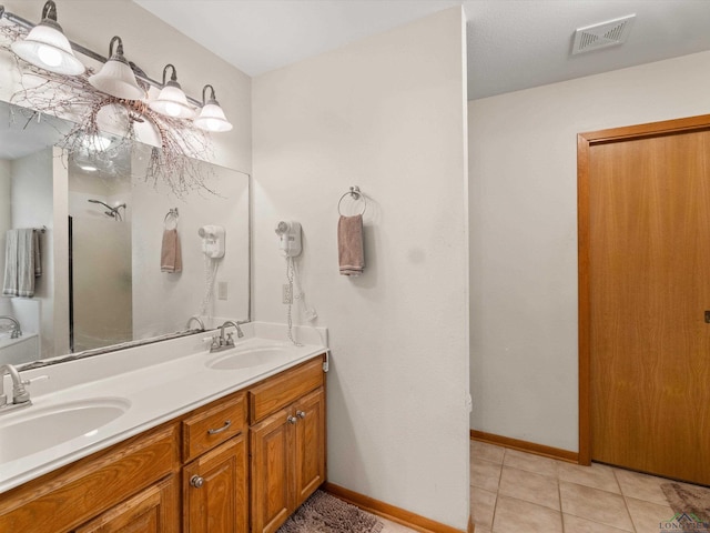 bathroom with tile patterned flooring and vanity